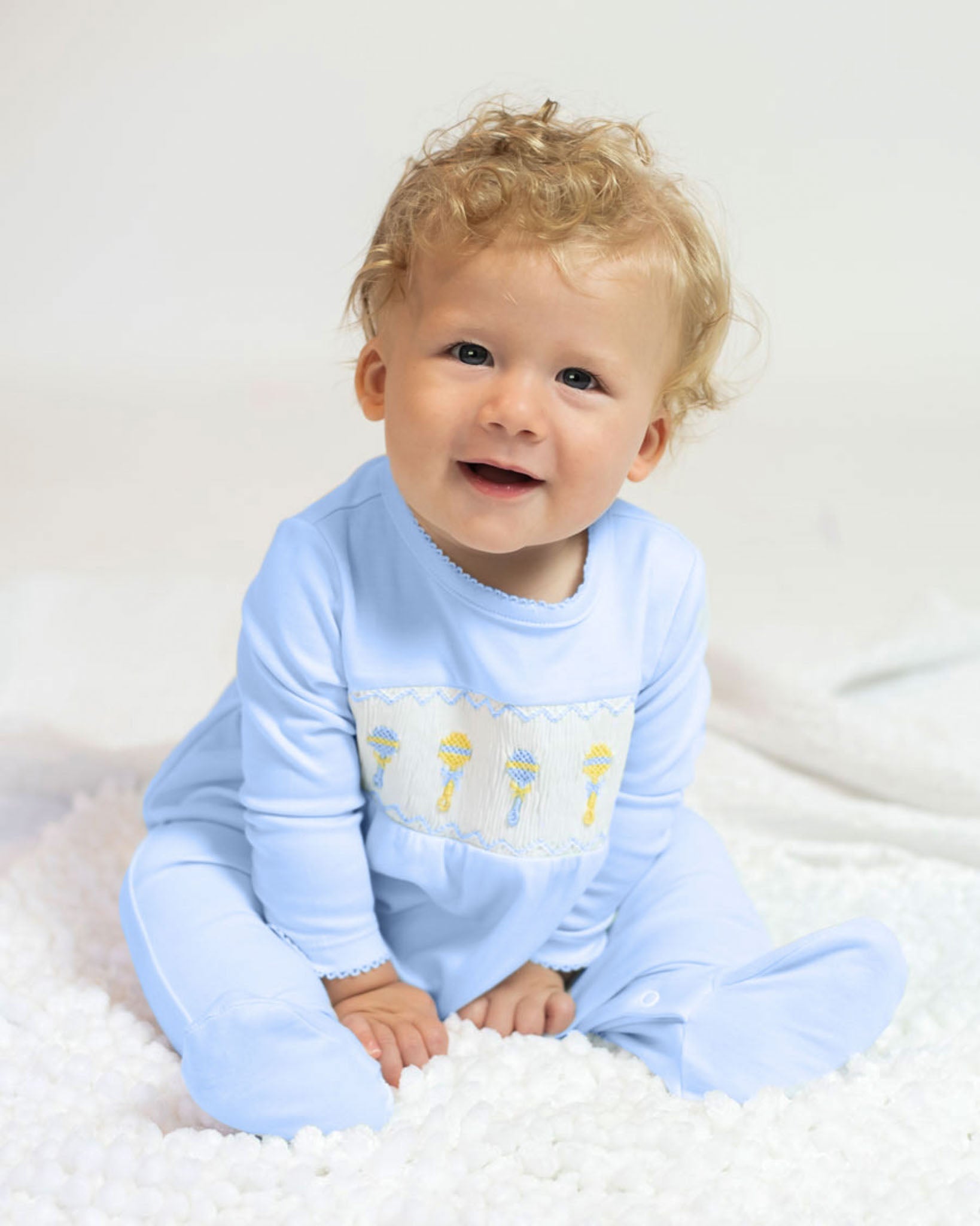 Baby Rattle Smocked Knit Onesie In Blue Smockingbird