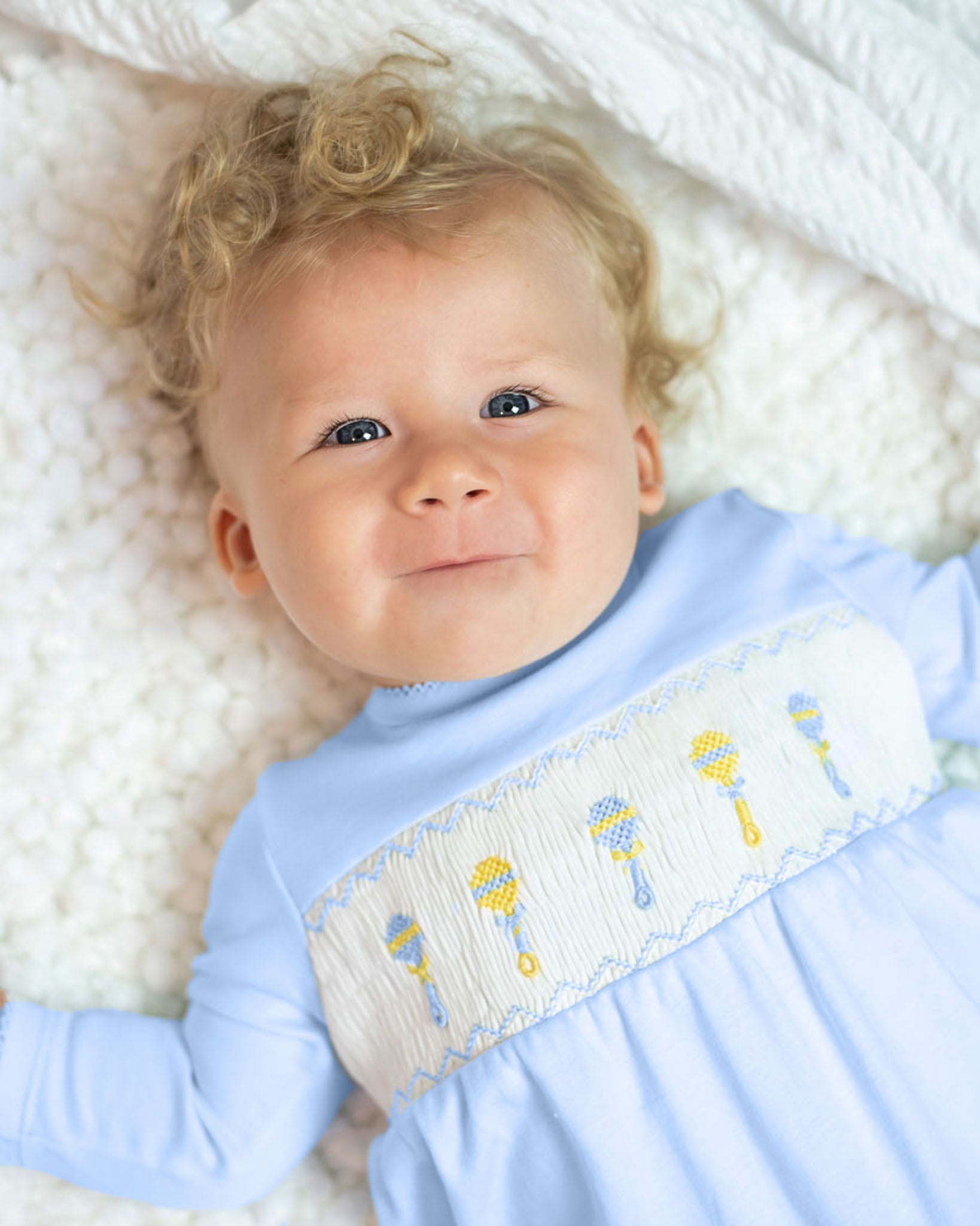 Baby Rattle Smocked Knit Onesie In Blue Smockingbird